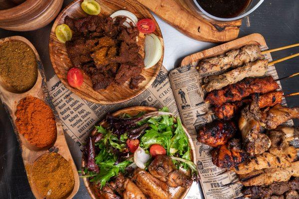 Disbe Good platter with beef suya, chicken suya, teriyaki chicken, jerk chicken and grilled chicken wings.