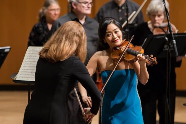 Chicago Philharmonic violinist Kathleen Brauer (left) and soloist Chee-Yun (right) in Vivaldi's "Four Seasons."  Photo by Elliot Mandel.