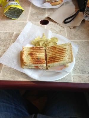 Chicken cordon bleu panini with rosemary and olive oil potato chips.