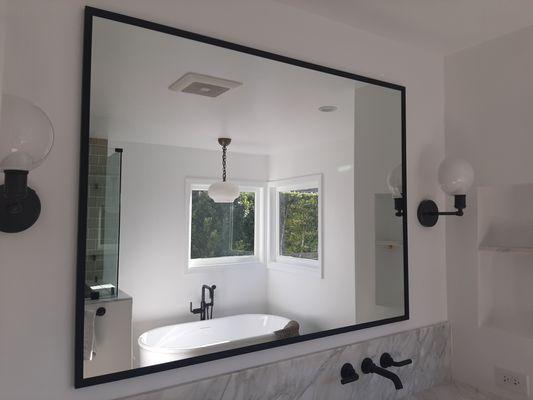 Custom framed oil rubbed bronze 'U' channel framed mirror installed.