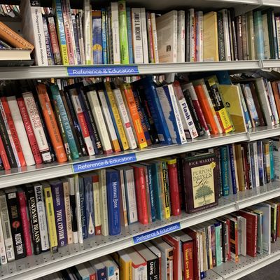 shelves of books, catalogues, dc memorabilia