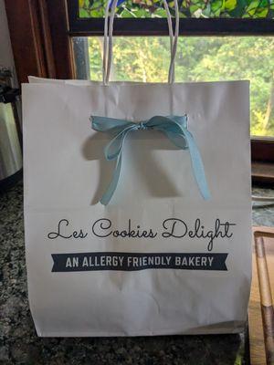 Cute gift bag full of treats with an adorable blue bow.