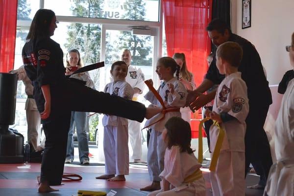 The "Dragon's Kiss"! The kids like the belt promotion ceremony. Photo Credit: Elissa Overton