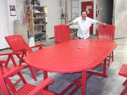 Kelly Moore Queen of Hearts Red on beach table made out of Natural Teak wood.