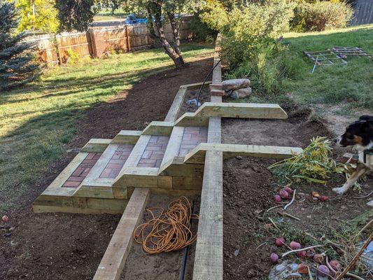 Retaining wall with large planters and steps.