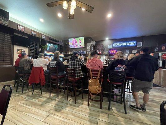 Behind the small bar area. It is a full bar.