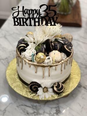 Gold Drip cake with macarons, chocolate covered strawberries and Ferrero rocher. Butter cake with cream cheese pecan filling!