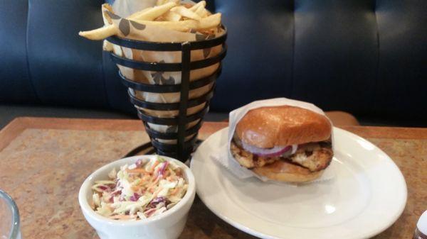 Grilled chicken sandwich with coleslaw and fries