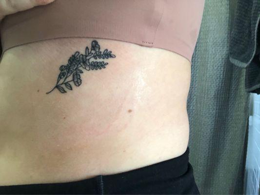 My tattoo on my rib cage with the tape on it still.