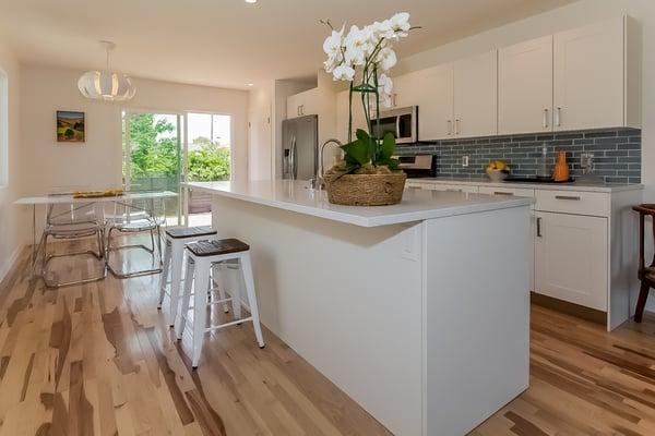 Lovely renovation by Studio Skaggs Kennedy: Solid Hickory hardwood floors, Caesarstone counters,Heath tile backsplash, & more...