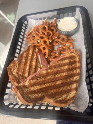 Great Reuben and seasoned pretzels from the Driftwood Deli attached to By George