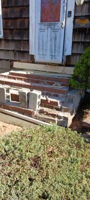 Breaking up old stoop and preparing to rebuild stoop and new paver walk .