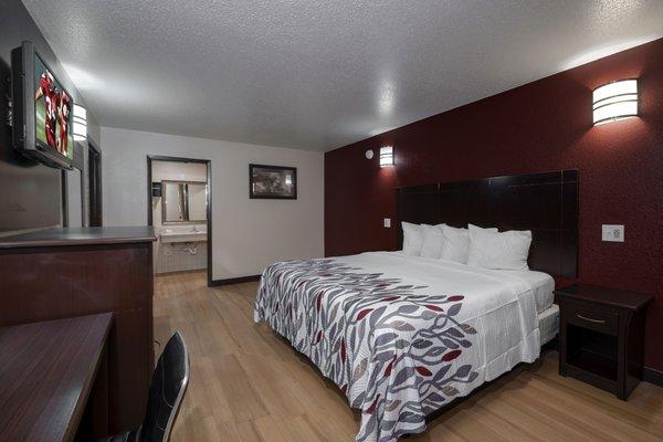 King room with new bedding and great wood-like flooring.