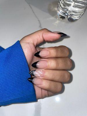 Black French tips with a spider web design