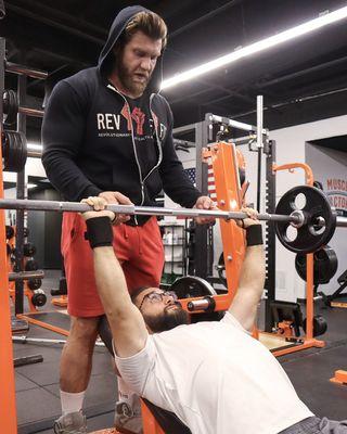 Coach Ryan and David incline bench pressing.