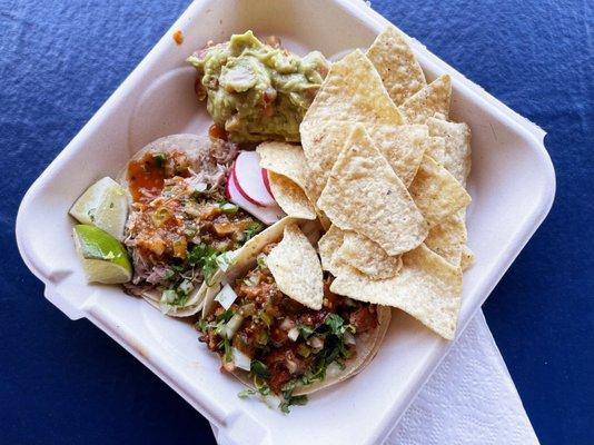 Carnitas and pastor tacos with chips and guac