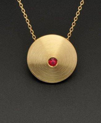 Cymbal pendant with flush/bright-set ruby in 18k yellow gold. Brush/satin finish. An Apricot original.