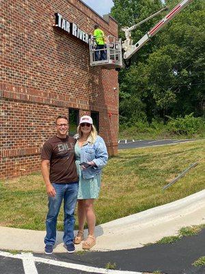 Owners Kurt and Ivy Lieberman in front of the new Tar River Arms writhing Youngsville Gun Club & Range