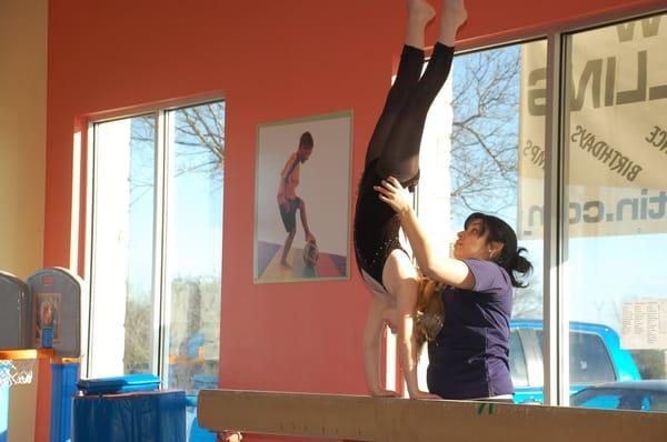 A thrilling handstand on the high beam!