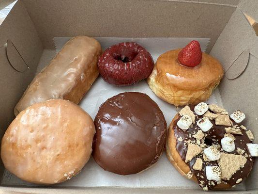 Maple bar, red velvet, crème brûlée, raspberry filled, custard filled, and s'mores donuts