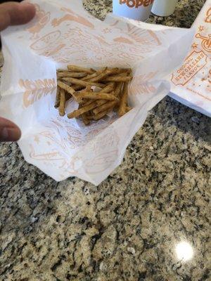 Fries thrown in a bag.