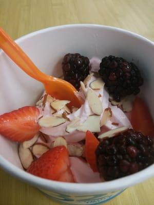 Strawberry yogurt with almonds, strawberries and blackberries.