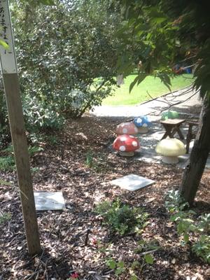 Whimsical mushroom seating in an "outdoor classroom" at Grace Cooperative Preschool. Perfect for science lessons and storytime.