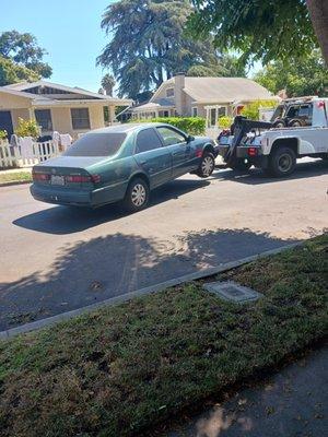 My car being pampered and towed into my driveway 30 feet long.