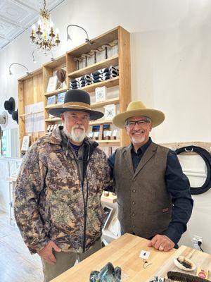 Owner George and a happy customer with one of our signature Jim Fox hats