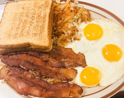 Eggs hash browns bacon and toast