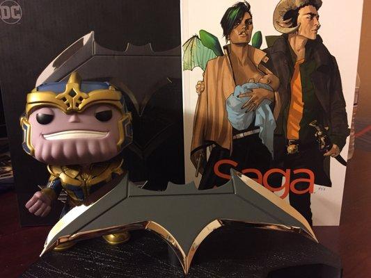 Batman Batarang Prop, the recommended Saga comics by the associates and a Funko Thanos.