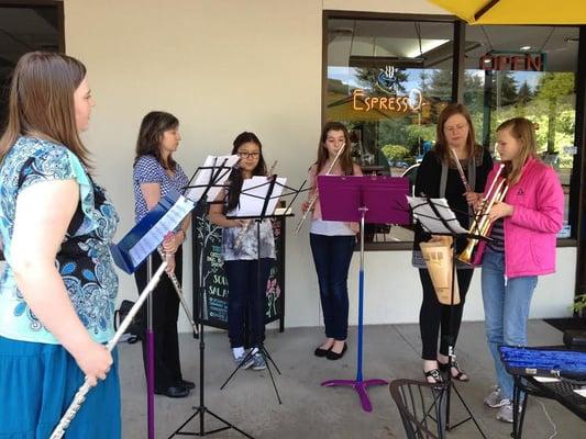 Jean Balogh and students performing outside the B&R coffee shop.