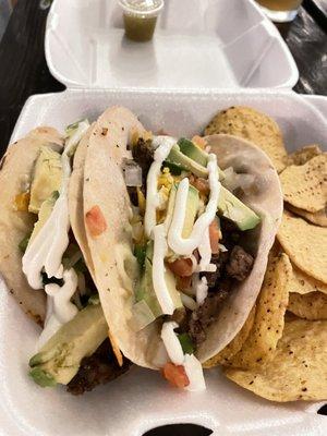 Carne Asada tacos with sour cream and avocado