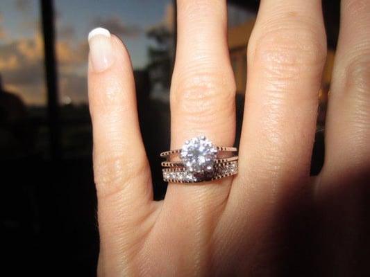 The engagement ring is an heirloom. The band was custom made by Weiss to match its unique shape and structure.