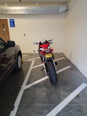 Motorcycle blocking the handicapped access to our car. Want to try to get a wheelchair between it and my car?