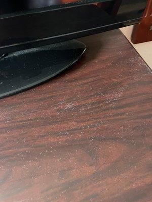 Dust and mildew on the tv stand.