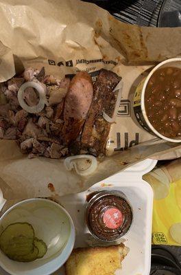 Pork ribs; Chopped beef brisket; Polish kielbasa Sausage; Texas bread; pickles; onions; Texas hot sauce; red beans dinner roll.