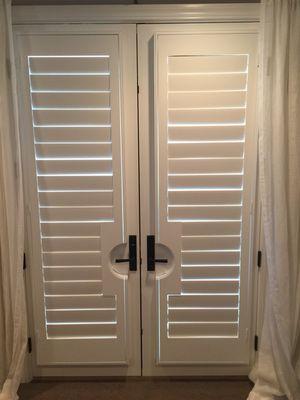 * 4 1/2 inch louvered basswood Shutters * Hidden tilt rod * Installed on French doors with cut outs for door levers