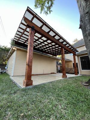 Stamped concrete addition, cedar pergola with electrical, and polycarbonate system.