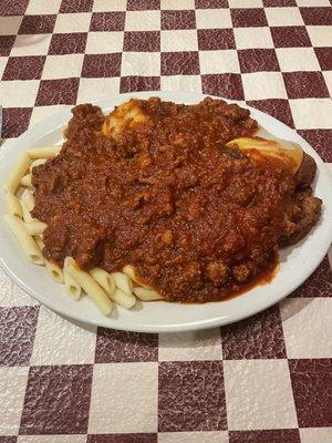 Massive chicken cutlet parmigiano with penne pasta and meat sauce