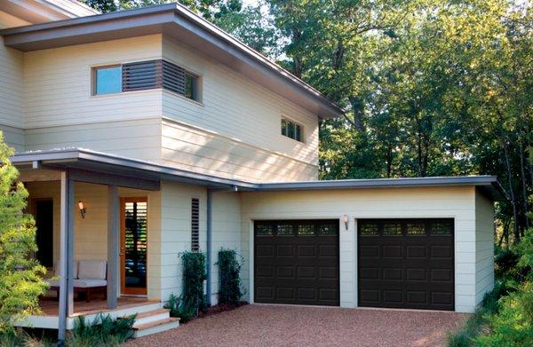 Dark colored garage doors with window inserts