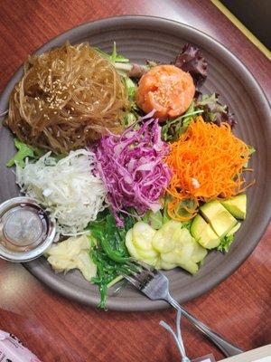 Sweet potato noodle, raw salmon, cucumber, avocado, shredded carrots, red & white cabbage, green salad, seaweed salad, pickled ginger