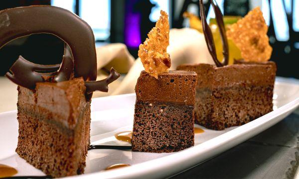 DRUNKEN CHOCOLATE BOURBON CAKE, maker's mark chocolate mousse cake, crisp pecan tuile, warm bourbon spiked caramel sauce