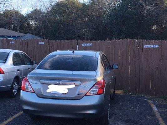 Visitor parking which is all the way across on the opposite side of the apartments is plastered with signs on the fence and ground.