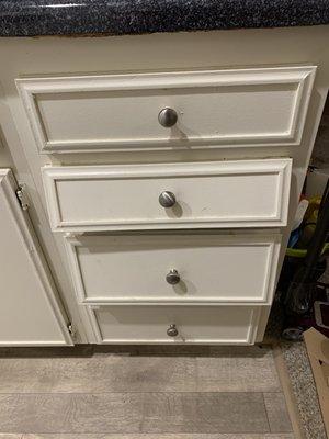 Both sets of drawers (there's another next to the stove) don't have full treads for them to sit on, so they hang.