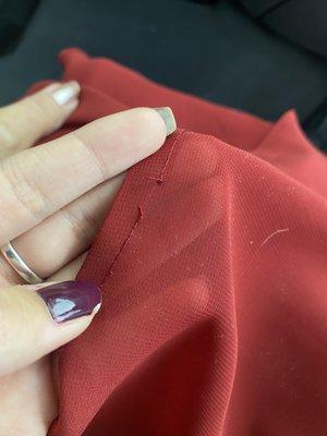 a broken stitch that can easily come loose if snagged or pulled on.