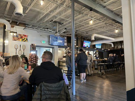 The bar area with two tap stations and pizza kitchen in the back.