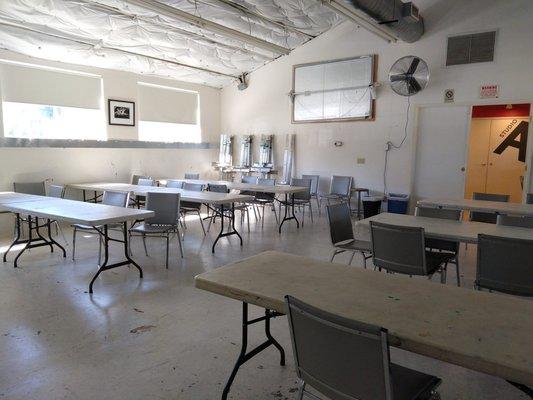 Studio B Classroom with Tables, Chairs, Easels, & Demo Mirror.