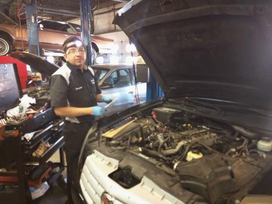 Fernando Pausing to say hi! as he reinstalls an intake manifold.