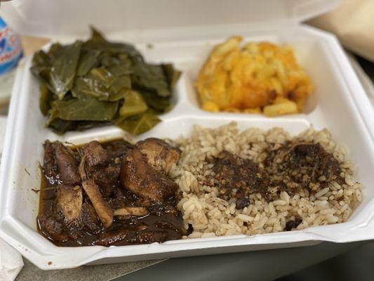 Caribbean jerk chicken plate with rice, beans, and two sides.